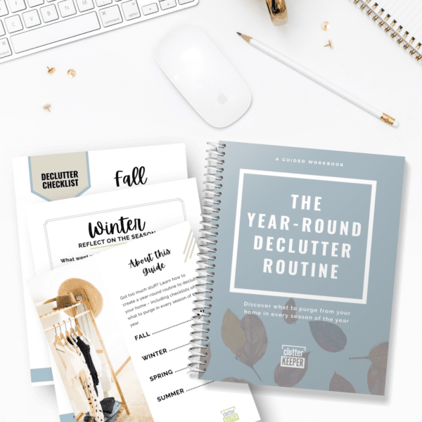 The Year-Round Declutter Routine on a desktop with several pages from the guided workbook